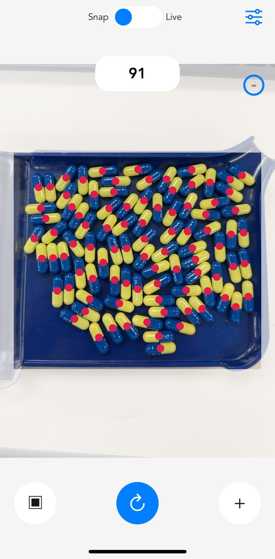 pillphill counting a tray of two-tone capsules